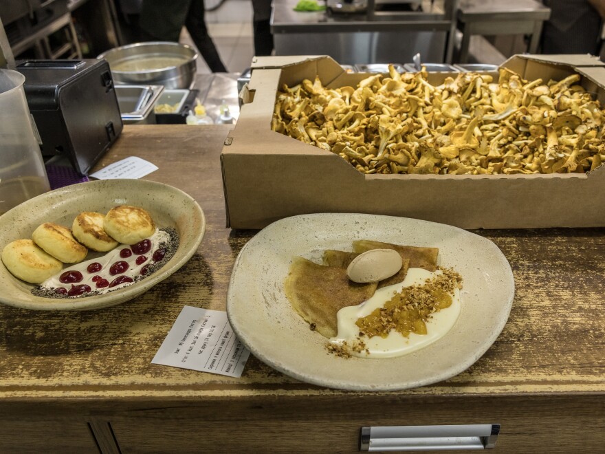 Prepared meals wait to be picked up by the waiter in the kitchen of Yevhen Klopotenko's restaurant 100 rokiv tomu vpered in Kyiv on Aug. 14.