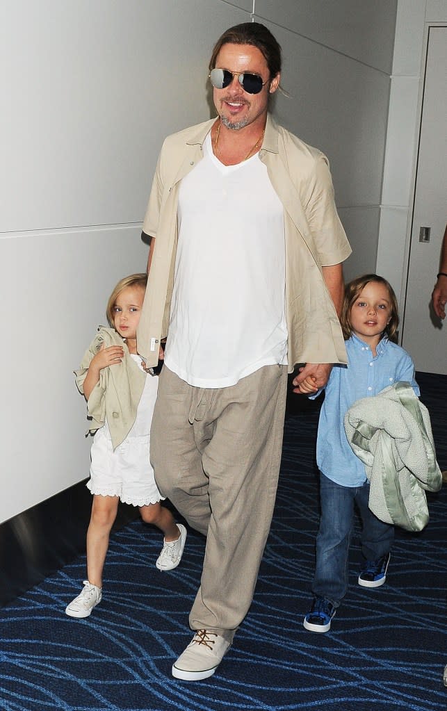 Brad Pitt with his kids Knox and Vivienne in Tokyo in 2013. WireImage