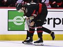 Ottawa Senators centre Josh Norris heads to the dressing room for medical attention after being cross-checked head-first into the boards by Vancouver Canucks defenceman Quinn Hughes in NHL game at Ottawa on Saturday, Nov. 23, 2024.