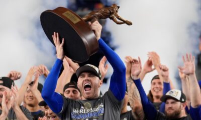 Los Angeles Dodgers' Freddie Freeman celebrates with the MVP trophy after their win against the New York Yankees in Game 5 to win the baseball World Series, Oct. 31, 2024, in New York. (AP Photo/Ashley Landis)