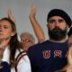 Recently retired Philadelphia Eagles lineman Jason Kelce and wife Kylie watch a women's field hockey match Saturday, July 27, 2024, in Colombes, France. (AP Photo/Anjum Naveed)