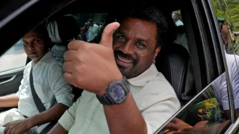 Reuters Sri Lanka's President and National People's Power (NPP) party leader Anura Kumara Dissanayake gestures as he leaves after casting his vote on the day the parliamentary election in Colombo, Sri Lanka, November 14, 2024.