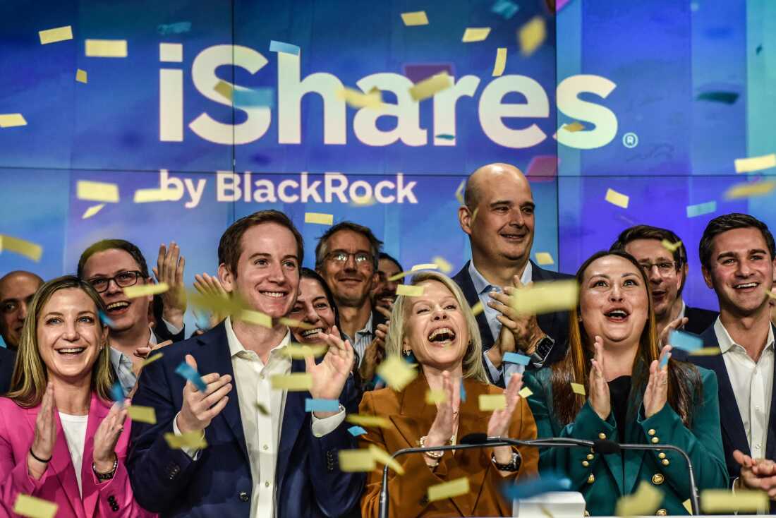 Executives of investment firm BlackRock ring the opening bell as investment funds tied to bitcoin are launched on the Nasdaq Exchange on Jan. 11, 2024 in New York City. The launch of these investment funds have helped bitcoin go more mainstream.