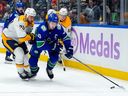 Quinn Hughes skates away from Ryan O'Reilly of the Predators during  Nov. 17 game at Rogers Arena.