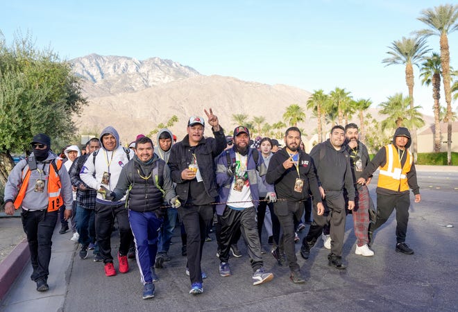 People walk in the morning along Hwy 111 in Palm Springs on the pilgrimage to Coachella during the annual Virgen de Guadalupe route through the Coachella Valley, Dec. 12, 2024.