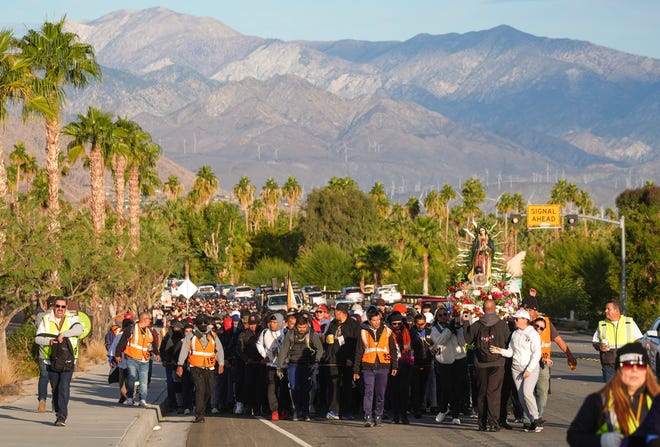 Participants in the Virgen de Guadalupe pilgrimage walk in the morning along Hwy 111 in Palm Springs, Calif., Dec. 12, 2024.