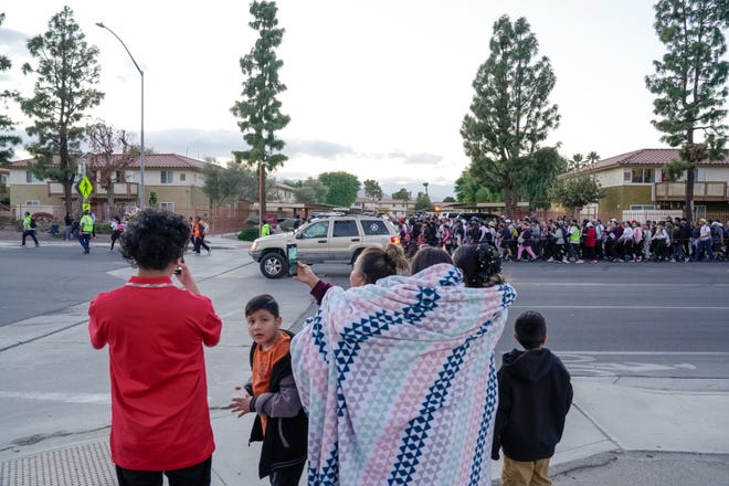 People watch as the Virgen de Guadalupe pilgrimage passes through Indio, Calif., Dec. 12, 2024.