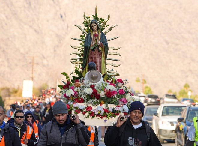 Participants in the Virgen de Guadalupe pilgrimage walk in the morning along Hwy 111 in Palm Springs, Calif., Dec. 12, 2024.