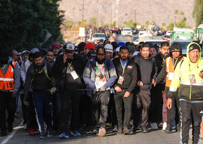 Participants in the Virgen de Guadalupe pilgrimage walk in the morning along Hwy 111 in Palm Springs, Calif., Dec. 12, 2024.