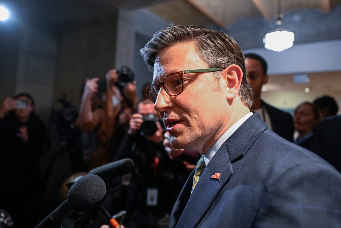 U.S. House Speaker Mike Johnson is seen speaking with reporters on Capitol Hill.