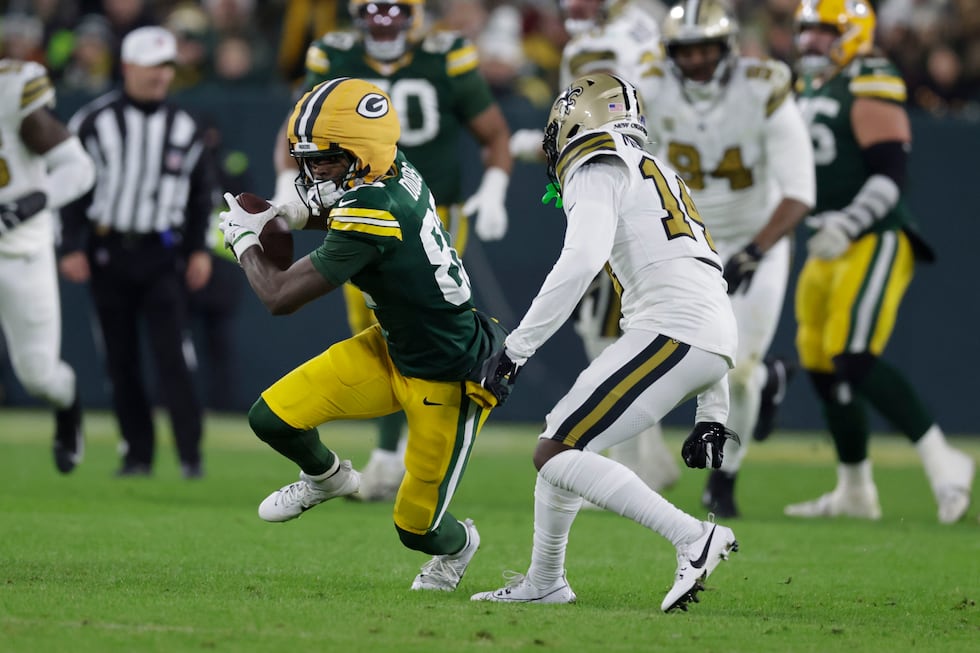 Green Bay Packers wide receiver Romeo Doubs (87) carries on a first down reception against New...