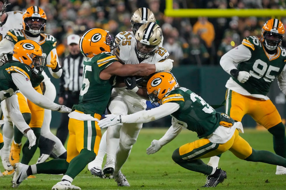 New Orleans Saints running back Kendre Miller (25) is stopped by Green Bay Packers linebacker...