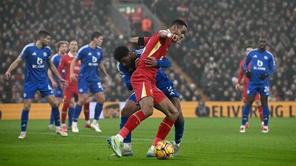 Liverpool's Dutch striker #18 Cody Gakpo fights for the ball with Liverpool's English defender #02 Joe Gomez