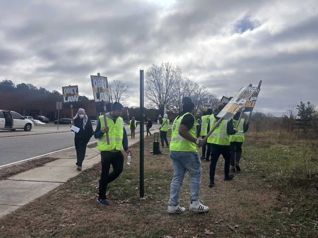 Workers outside an Amazon facility in Alpharetta, Georgia, form a picket line on December 19, 2024.