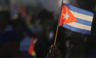 A person waves a Cuban flag during a gathering marking International Workers' Day at Anti-Imperialist Square in Havana, Cuba, May 1, 2024. (AP Photo/Ariel Ley)