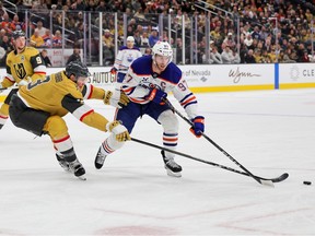 LAS VEGAS, NEVADA - DECEMBER 03: Connor McDavid #97 of the Edmonton Oilers skates with the puck against Brayden McNabb #3 of the Vegas Golden Knights in the first period of their game at T-Mobile Arena on December 03, 2024 in Las Vegas, Nevada.