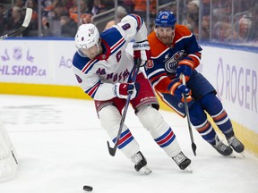 New York Rangers Jacob Trouba battles Edmonton Oilers Connor Brown for the puck