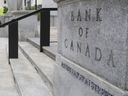 Pedestrians walk past the Bank of Canada in Ottawa on July 12, 2023.