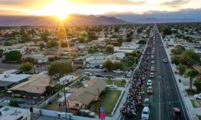 The sun begins to set as hundreds of people walk along Miles Ave during the Virgen de Guadalupe pilgrimage through the Coachella Valley as it passes through Indio, Calif., Dec. 12, 2024.