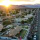 The sun begins to set as hundreds of people walk along Miles Ave during the Virgen de Guadalupe pilgrimage through the Coachella Valley as it passes through Indio, Calif., Dec. 12, 2024.