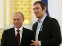 MOSCOW, RUSSIA - MAY 27:  Russian President Vladimir Putin (L) and  Russian Ice Hockey team player Alexander Ovechkin (R) stand together during a reception for national team who won the 2014 Ice Hockey World Championshon, in the Kremlin May 27, 2014 in Moscow, Russia. The Russian team met with Putin after a parade through the streets of Moscow celebrating their win over Finland.