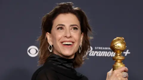 Getty Images Fernanda Torres holding the Golden Globe award 