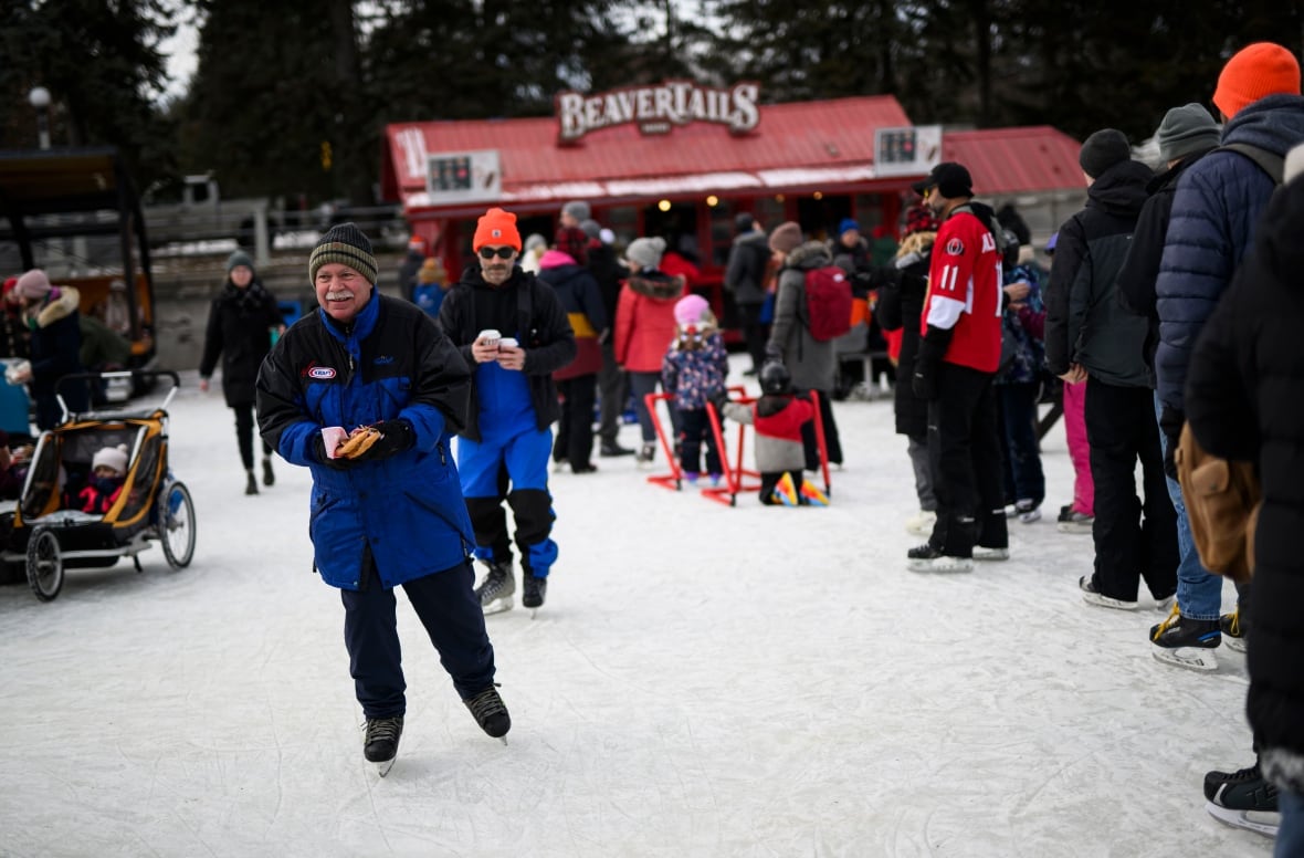 People in line on the Rideau Canal at a BeaverTails kiosk.