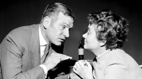 PA Media Black and white photo of Laurence Olivier and Joan Plowright facing each other in rehearsals for The Entertainer