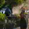 :A woman tries to cool off with a fan that spray water to refresh people during a hot day as the National Weather Service on Monday issued a warning due to hot weather that will remain in effect until Wednesday night in New York City, United States on July 15, 2024.