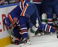 Corey Perry drops Quinn Hughes on his head during a mid-game tussle Thursday in Edmonton.