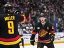 Elias Pettersson listens to instructions from J.T. Miller before a faceoff at a game in New Jersey last October.