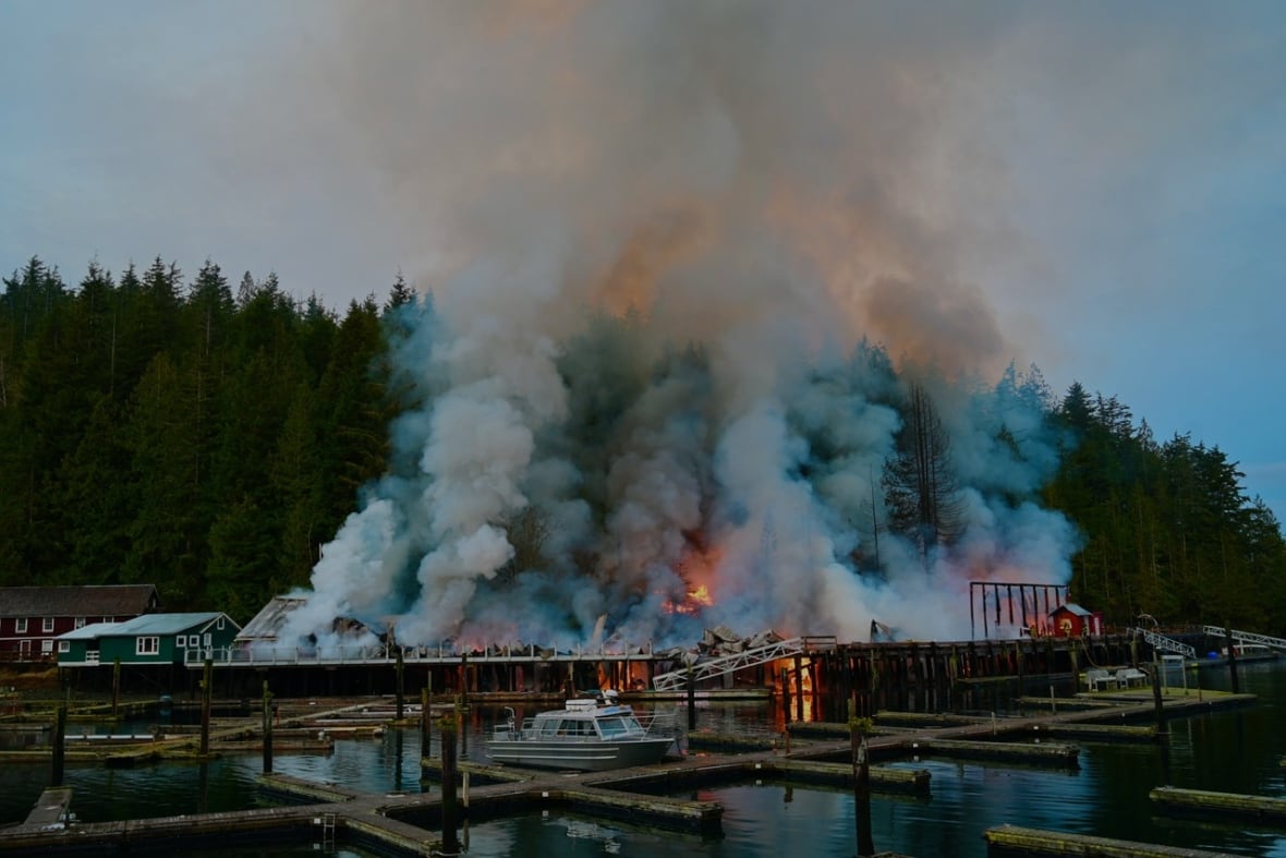 Smoke and flames rise from a boardwalk.