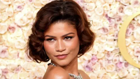 Getty Images Zendaya smiling on the red carpet of the Golden Globes 