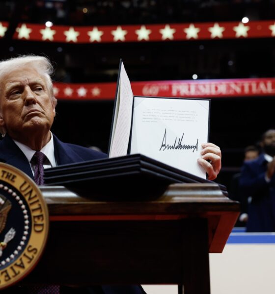 President Donald Trump holds up an executive order after signing it during an indoor inauguration parade at the Capital One Arena on Jan. 20, 2025, in Washington, D.C. (Photo by Anna Moneymaker/Getty Images)