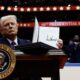 President Donald Trump holds up an executive order after signing it during an indoor inauguration parade at the Capital One Arena on Jan. 20, 2025, in Washington, D.C. (Photo by Anna Moneymaker/Getty Images)