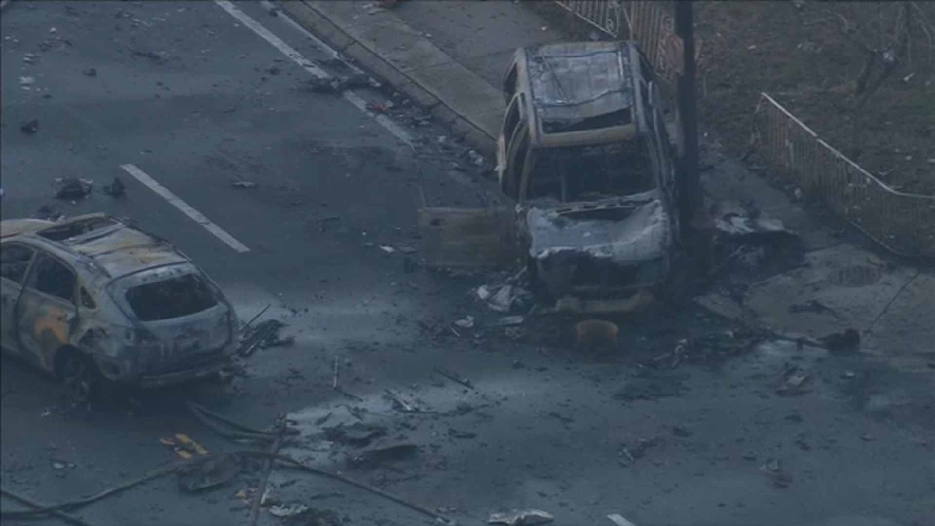 Charred vehicles are left amid the destruction after a medical jet crashed in Northeast Philadelphia